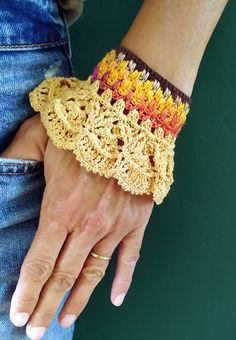 Crafted with love and attention to detail, this unique crochet cuff bracelet combines the colors of nature - peach, yellow, brown, purple and orange. Wear it as a symbol of your individuality and passion for life. Add charm and style to any look with this true piece of handmade art. Comes in FREE cute jewelry holder! Colors might slightly differ! SIZE Measurements: the distance from a button to it's hole  Length: 17 cm/ 6,70 in Width: 7 cm/ 2.75 in HOW TO TAKE CARE The bracelet can be washed wit Handmade Yellow Cuff Bracelet, Handmade Orange Cuff Bracelet Gift, Handmade Orange Cuff Bracelet Bangle, Handmade Orange Cuff Bangle, Handmade Orange Bangle Cuff Bracelet, Bohemian Crochet Bracelets As Gift, Yellow Bohemian Cuff Bracelet As Gift, Bohemian Yellow Cuff Bracelet Gift, Yellow Crochet Bohemian Jewelry