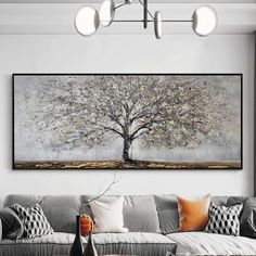 a living room with a couch, coffee table and large painting on the wall above it