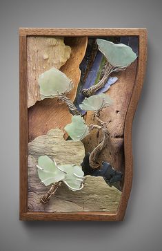 a piece of wood with sea glass in it