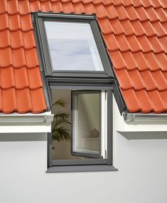 an orange tiled roof with a skylight window