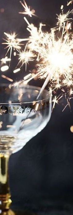 a wine glass filled with champagne and sparklers