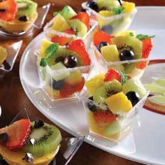 fruit tarts are arranged on small trays