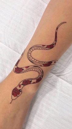 a woman's arm with a tattoo on it and a snake in the middle