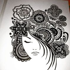 a black and white drawing of a woman's head with flowers in her hair