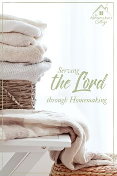 a stack of folded towels sitting on top of a white table next to a basket