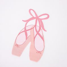 pair of pink ballet shoes on white background with ribbon tied around the toe and heel