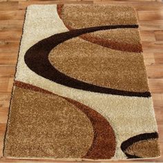 a brown and tan area rug on top of a hard wood floor next to a wooden floor