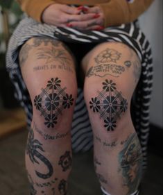 a woman with tattoos on her legs sitting down