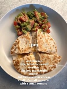 a white plate topped with quesadillas and guacamole on top of it