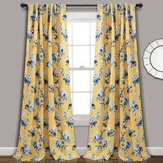 a window with yellow curtains and blue flowers on it