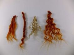 three different types of hair on a white surface