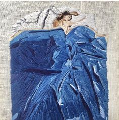 an image of a woman laying in bed with her head on the pillow and she is wearing a blue dress