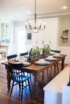 the dining room table is set with place settings