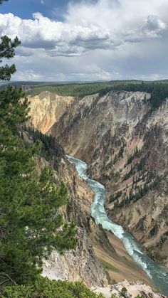 a river flowing through a canyon surrounded by trees