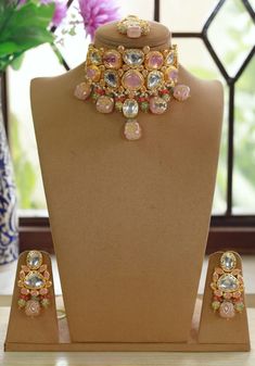 Dazzling kundan Polki stones with crystal-work teamed with a delicate gold frame instantly elevate any outfit. The set includes a pair of matching earrings and Maang Tika  Approximate earrings length is 2.5 inch Free Shipping A set that has been designed with attention to detail and will compliment any outfit! Chandbali Kundan Necklace Jeweled, Bollywood Style Jewelry With Zari Work For Designer Wear, Bollywood Style Designer Jewelry With Zari Work, Designer Kundan Jeweled Jewelry, Kundan Jeweled Jewelry Sets For Celebration, Celebration Kundan Jeweled Jewelry Sets, Festive Kundan Bridal Necklace With Jeweled Details, Pink Kundan Temple Necklace With Meenakari, Festive Jeweled Kundan Necklace For Diwali