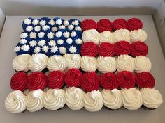 a box filled with cupcakes covered in red, white and blue frosting