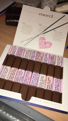 there is a box of chocolates with writing on it and a pair of scissors