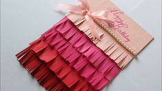 a pink and red birthday card with ribbon