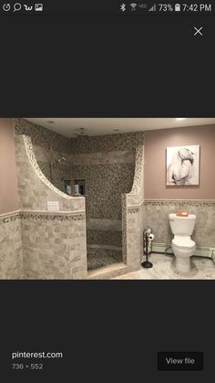 an image of a bathroom that is being viewed from the front view mirror, with pictures on the wall