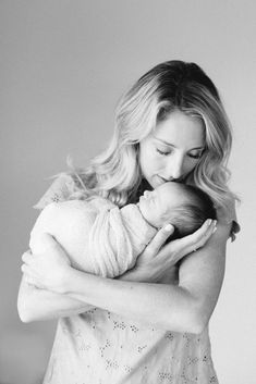 a woman holding a baby in her arms