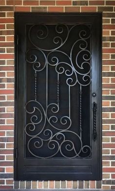 a black iron door on a brick wall