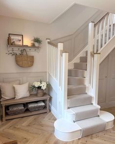 the stairs in this house are made of wood and have been painted white with gray carpet