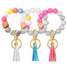 four bracelets with different colored beads and tassels hanging from each bead