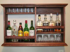 a shelf filled with liquor bottles and glasses