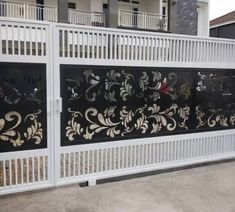 a white fence with black and gold designs on it