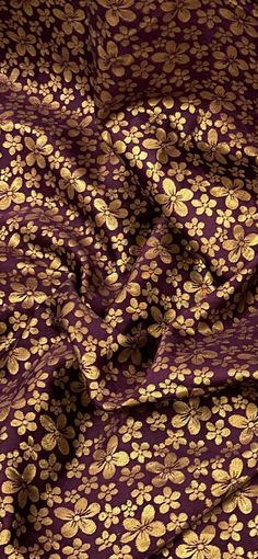 a purple and gold floral print fabric