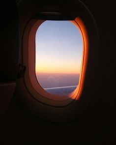 an airplane window looking out at the sky