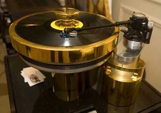 a golden record player on top of a black table