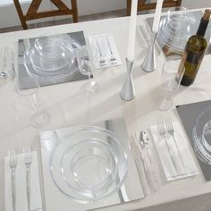 the table is set with silverware and place settings