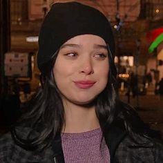 a woman wearing a beanie and looking at the camera