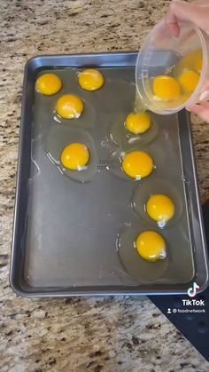 someone is pouring eggs into a pan on the counter