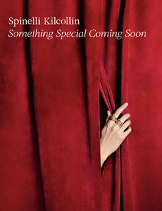 a woman's hand peeking out from behind a red curtain with the words, something special coming soon