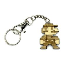 a wooden keychain shaped like an old school video game character