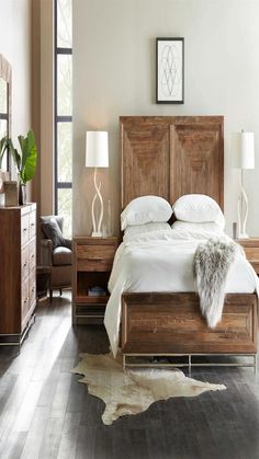 a bedroom with a bed, nightstands and two lamps on either side of the bed