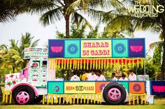 an elaborately decorated food truck is parked in the grass