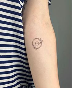 a woman's arm with a small tattoo on the left side of her arm