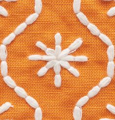 an orange background with white snowflakes in the center and on top of it