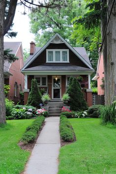 a house that is surrounded by trees and grass in the front yard with steps leading up to it