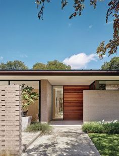 a modern house with brick and wood exterior