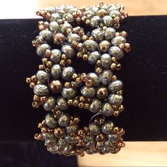 Nwot , Never Worn. 2 Row Flower Bracelet Made With Green French Pearls And Brown Pearl Centers Surrounded With Miyuki Gold Seed Beads. Beaded Loop Enclosures With Golden Hued Swarovski Crystals. 7” Length. I Made This Teaching A Class. Posh Ambassadortop Rated Seller Fast Shipper Adjustable Flower Beaded Bracelets For Parties, Party Metal Beaded Bracelets With Black Beads, Gold Flower Beaded Bracelets For Party, Gold Flower-shaped Beaded Bracelets For Parties, Gold Floral Beaded Bracelets For Parties, Handmade Metal Flower Bracelet, Elegant Handmade Flower Beaded Bracelets, Elegant Flower-shaped Beaded Bracelets For Party, Elegant Flower-shaped Beaded Party Bracelet