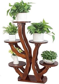 three tiered wooden plant stand with potted plants