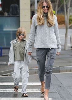 the woman and child are crossing the street