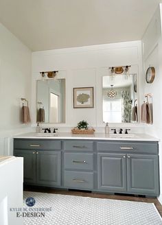 a large bathroom with two sinks and mirrors