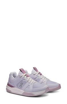 a women's tennis shoe in grey and pink