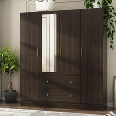 a brown armoire in a living room next to a potted plant