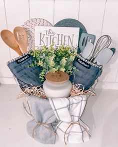 a kitchen gift basket filled with utensils and cookbooks on top of a counter